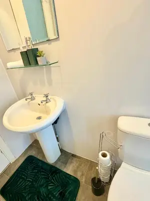a bathroom with a sink and a toilet at Comfort in the East in Glasgow