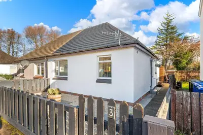a white house with a fence in front of it at Charming 2BR Oban Home - Quiet area with free parking in Oban