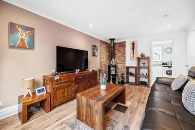 a living room with a couch and a flat screen tv at Charming 2BR Oban Home - Quiet area with free parking in Oban