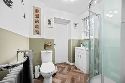 a bathroom with a toilet and a shower at Charming 2BR Oban Home - Quiet area with free parking in Oban