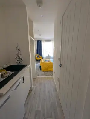 a kitchen with a door leading to a bedroom at YSquared studio in Falkirk
