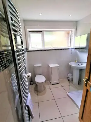 a bathroom with a toilet and a sink and a window at Stunning Coastal Home - Garden, Views, Pet Friendly in Connel