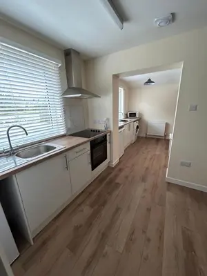 an empty kitchen with white cabinets and a sink at Tigh-Na-Croit in Whitehouse