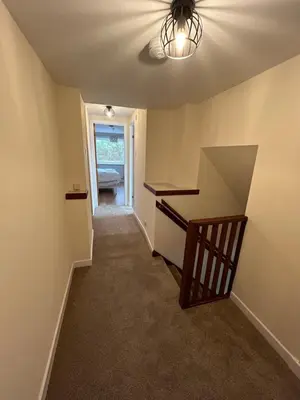 a room with a staircase with a ceiling fan at Tigh-Na-Croit in Whitehouse