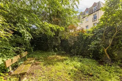 a park with a bench in front of a building at 3 Bedrooms Flat in Central Edinburgh New Town , Lothian Road in Edinburgh