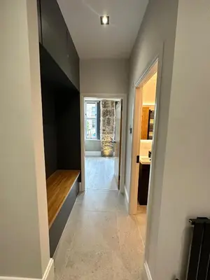 a hallway leading to a kitchen with a hallway leading into a house at Glasgow West End Tenement Apartment in Glasgow