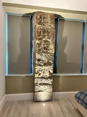 a stone pillar in a room with two windows at Glasgow West End Tenement Apartment in Glasgow