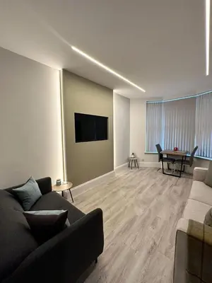 a living room with a couch and a table at Glasgow West End Tenement Apartment in Glasgow