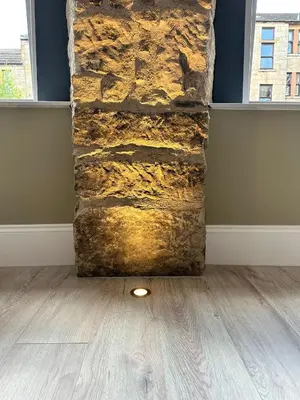 a stone wall with a light in a room at Glasgow West End Tenement Apartment in Glasgow