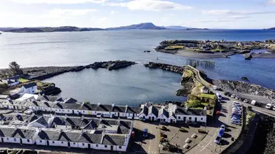 an aerial view of a resort by the water at Misty Isles Cottage- Ellenabeich, Easdale, Isle of Seil