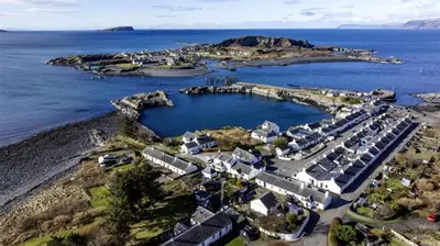 an aerial view of a small island in the ocean at Misty Isles Cottage- Ellenabeich, Easdale, Isle of Seil