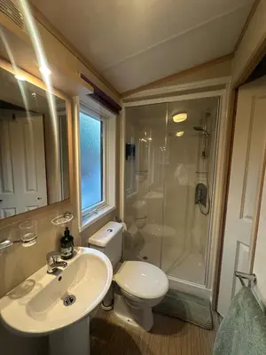 a bathroom with a toilet and a sink and a shower at Glen-coo in Auchterarder