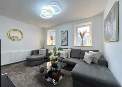 a living room with a couch and a table at Cosy Hideaway in Stirling