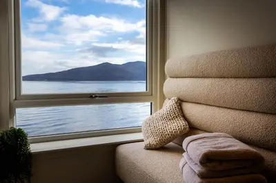 a window with a view of a body of water at The Shore House in Lamlash