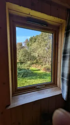 a window in a room with a view of a field at Bracken Lodge in Dalavich