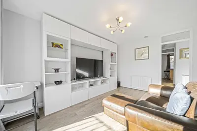 a living room with a couch and a tv at Lauriston 1 Bedroom Apartment - Edinburgh in Edinburgh
