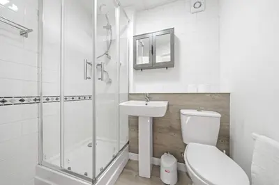 a bathroom with a toilet and a sink and a shower at Lauriston 1 Bedroom Apartment - Edinburgh in Edinburgh
