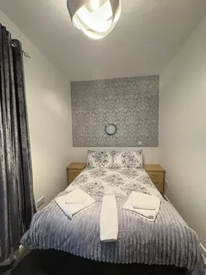 a bedroom with a bed with two towels on it at Glendale Guesthouse in Oban
