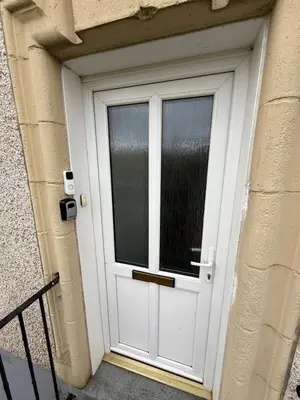a white door with a window on a building at Glasgow 2 Bedroom Apartment Access To City Centre in Gartcosh