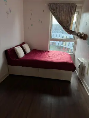 a small bed in a room with a window at Charming Edinburgh Apartment with Electric Heating Free WiFi in Edinburgh