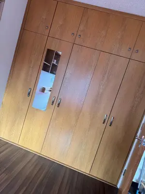 a wooden chest of drawers with a mirror at Charming Edinburgh Apartment with Electric Heating Free WiFi in Edinburgh