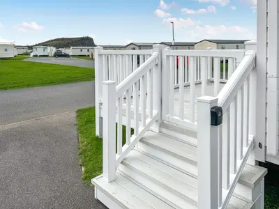 a white fence on the side of a house at Coastal Bay View in Ayr