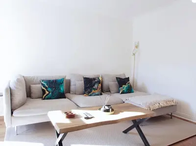 a living room with a couch and a coffee table at Fettes - Homely 2BD in Quiet Development in Edinburgh