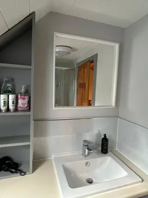 a bathroom with a sink and a mirror at Linlithgow cottage close to Edinburgh in Linlithgow