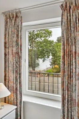 a window with a view of a street at Finest Retreats - Riverside View in Balloch