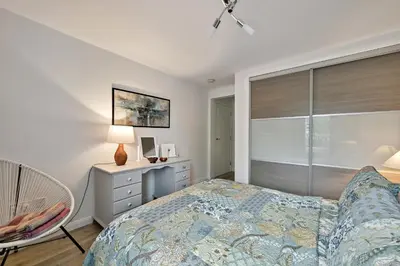 a bedroom with a bed and a desk and a window at Finest Retreats - Riverside View in Balloch