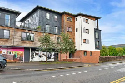 a building on the side of a street at Finest Retreats - Riverside View in Balloch