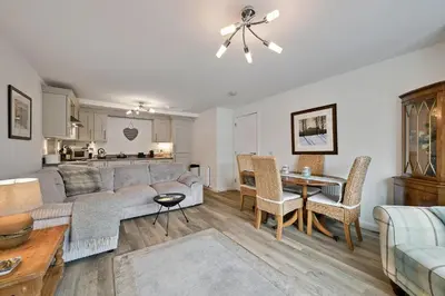 a living room with a couch and a table at Finest Retreats - Riverside View in Balloch