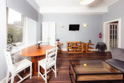 a living room with a table and a couch at Stylish and Unique Apartment by the Meadows 8 in Edinburgh