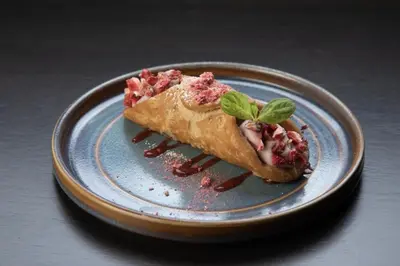 a blue plate with a piece of food on it at 2 Bedroom detached lodge overlooking Loch Lomond in Balloch