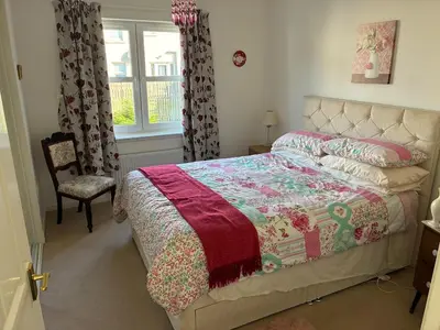 a bedroom with a bed and a chair and a window at Westcoast-Retreat-Largs in Largs