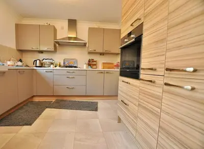 a kitchen with white cabinets and a stove top oven at Westcoast-Retreat-Largs in Largs