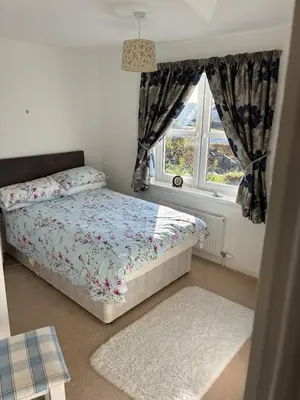 a bedroom with a bed and a window at Westcoast-Retreat-Largs in Largs