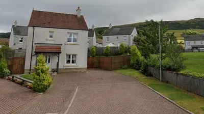 a large white house with a fence and a driveway at Westcoast-Retreat-Largs in Largs