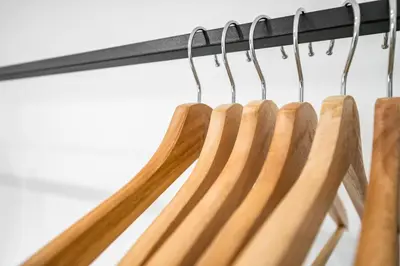 a bunch of wooden hangers in a closet at The Elphin Escape in East Kilbride