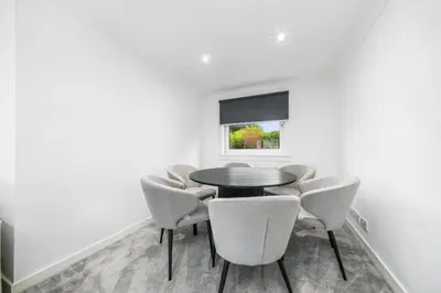 a dining room with a table and chairs at The Elphin Escape in East Kilbride