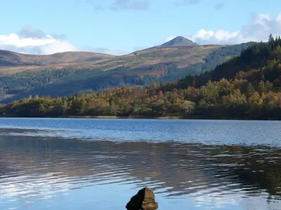 a view of a lake with mountains in the background at The Clachan Hotel, Lochearnhead in Lochearnhead