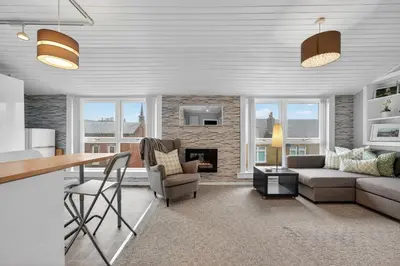 a living room with a couch and a table at Coastal Charm: Modern Retreat by Seafront in Largs