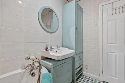 a bathroom with a sink and a mirror at Coastal Charm: Modern Retreat by Seafront in Largs