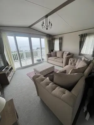 a living room with two couches and a large window at Wemyss Bay Beaumont Elite in Skelmorlie