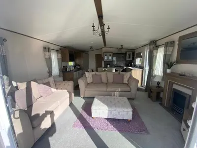 a living room with two couches and a fireplace at Wemyss Bay Beaumont Elite in Skelmorlie