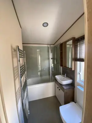 a bathroom with a sink and a tub and a toilet at Wemyss Bay Beaumont Elite in Skelmorlie