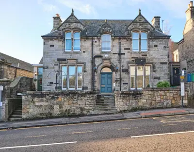 an old stone building on the side of a street at Bruce on the Row-Historic Elegance near Edinburgh by Urban Haggis Stays in Dunfermline
