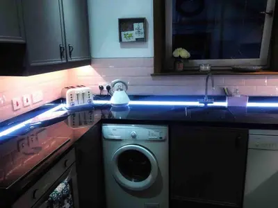 a kitchen with a washing machine in a kitchen at Close to beaches and golf courses in Maybole