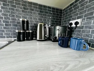 a kitchen counter with pots and mugs on it at Tigh Na Sealladh in Dunoon
