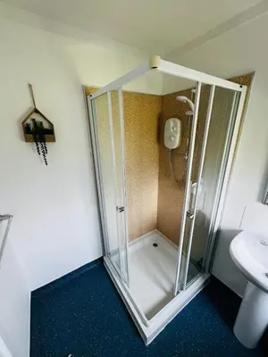 a shower stall in a bathroom with a sink at Tigh Na Sealladh in Dunoon